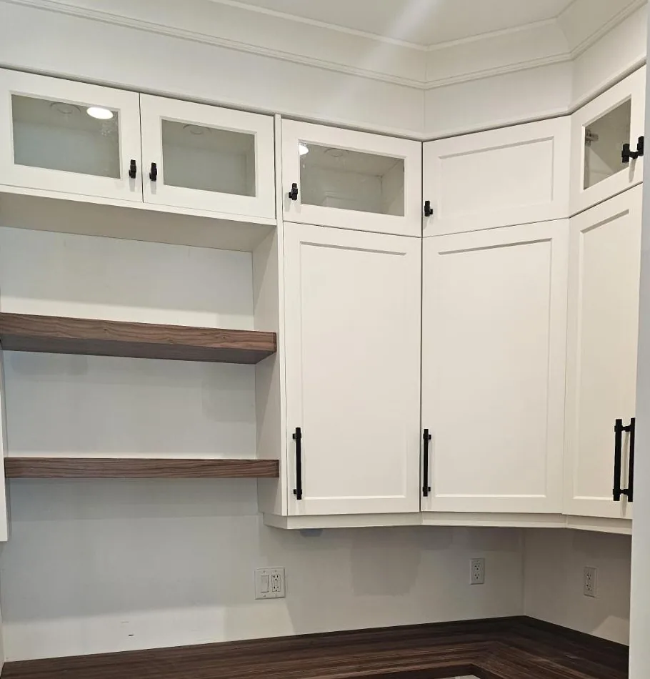 Corner pantry cabinetry with glass fronted upper doors and solid walnut floating shelves