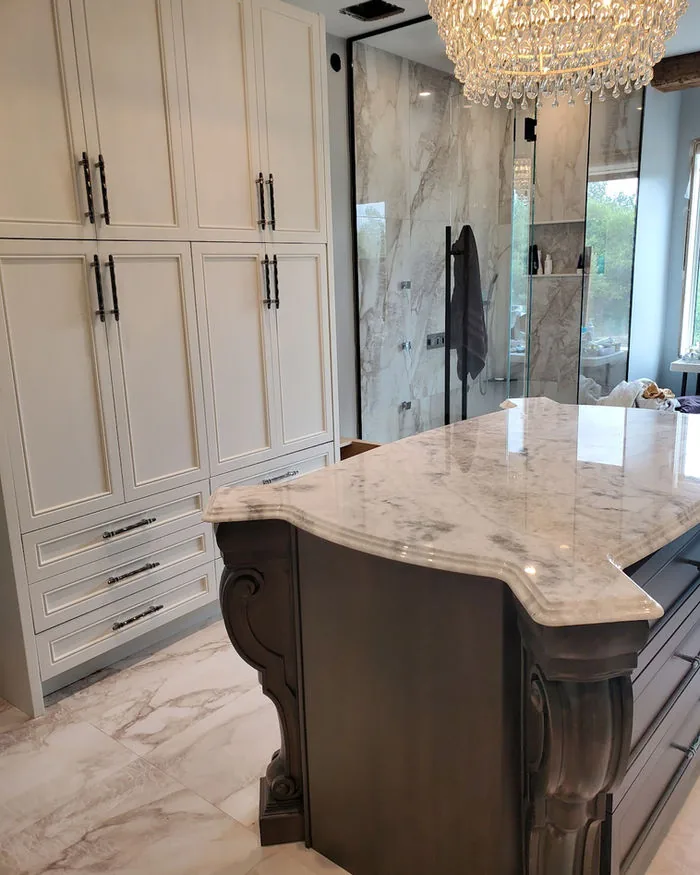 Leathered stone countertop with an ogee edge and carved corbel detail