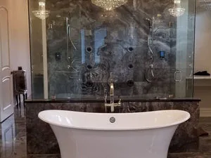 Marble tiled bathroom with a freestanding tub