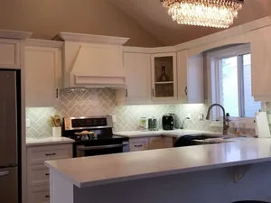 Shaker painted condo kitchen with a chandelier