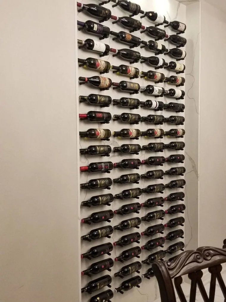 Floor to ceiling wine wall with metal peg racking