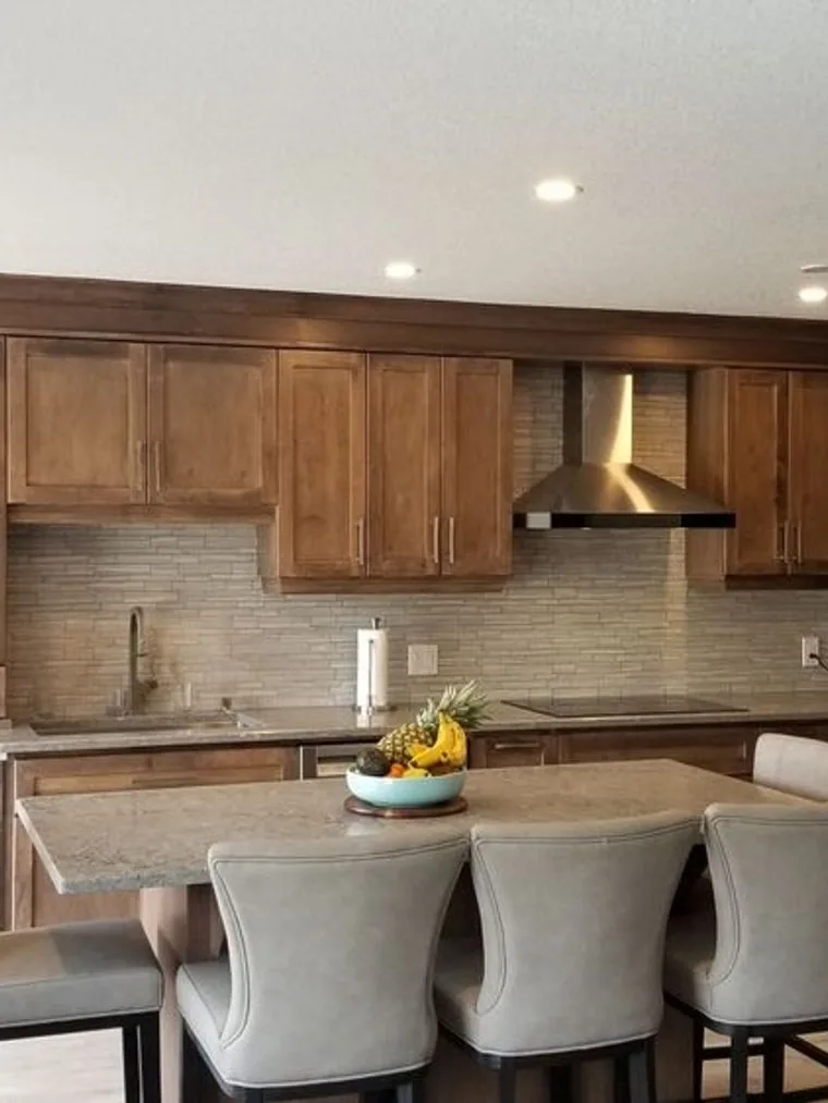 Modern Guelph kitchen with a natural wood finish and glass front upper cabinets